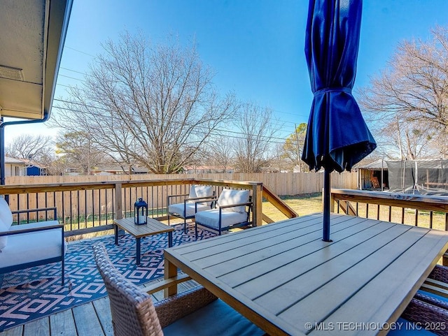 deck featuring a trampoline and outdoor lounge area