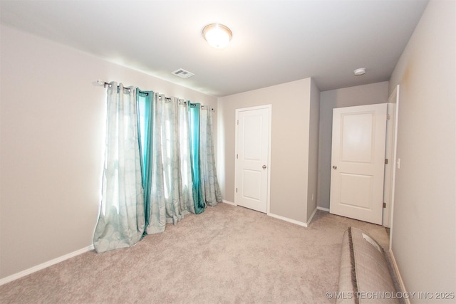 unfurnished bedroom with light colored carpet