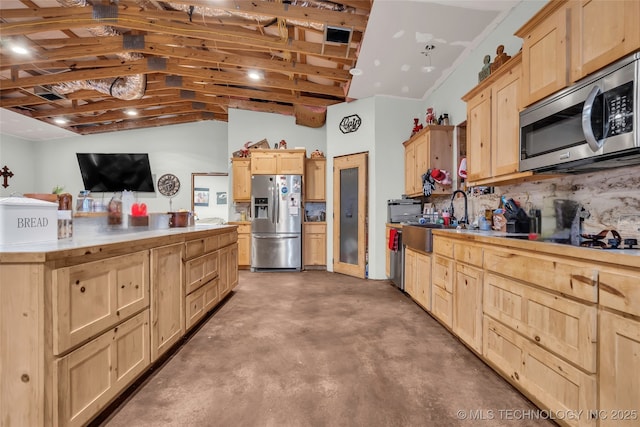 kitchen with stainless steel appliances, sink, light brown cabinets, and backsplash