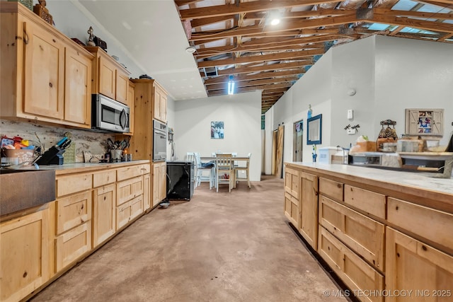 kitchen with appliances with stainless steel finishes and light brown cabinets