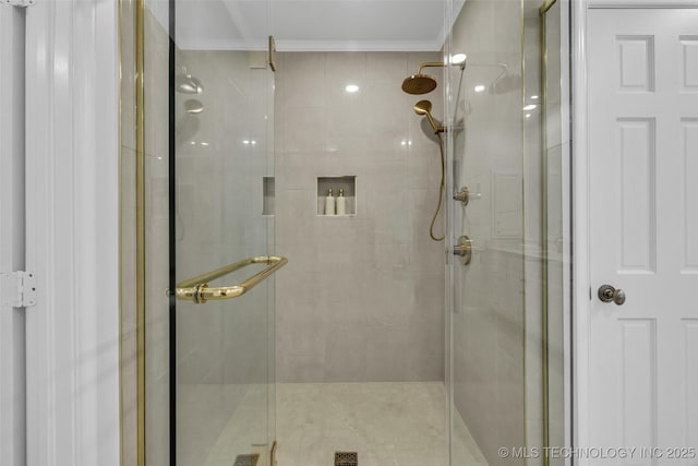 bathroom featuring ornamental molding and a stall shower