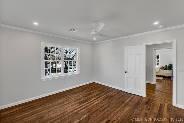 spare room featuring crown molding, recessed lighting, visible vents, dark wood-type flooring, and baseboards