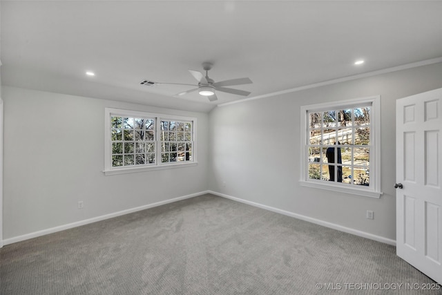 spare room with carpet floors, a healthy amount of sunlight, and visible vents