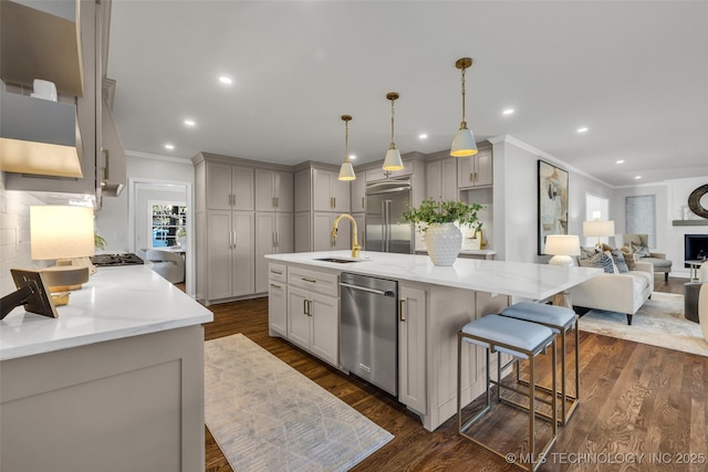 kitchen featuring crown molding, appliances with stainless steel finishes, dark wood-style flooring, and a sink