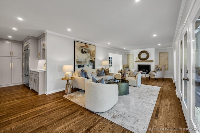 living room featuring dark wood-style floors, crown molding, and recessed lighting