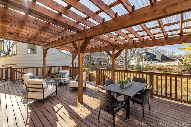 deck with outdoor dining space, fence, and a pergola