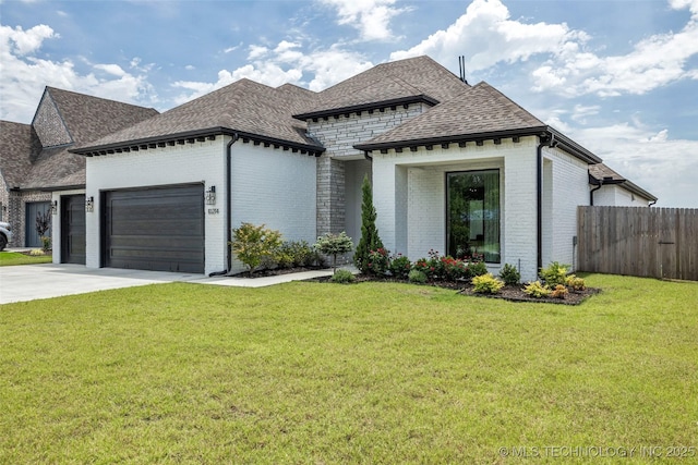 view of front of property featuring a garage and a front yard