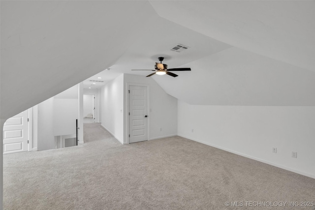 additional living space featuring lofted ceiling and light carpet