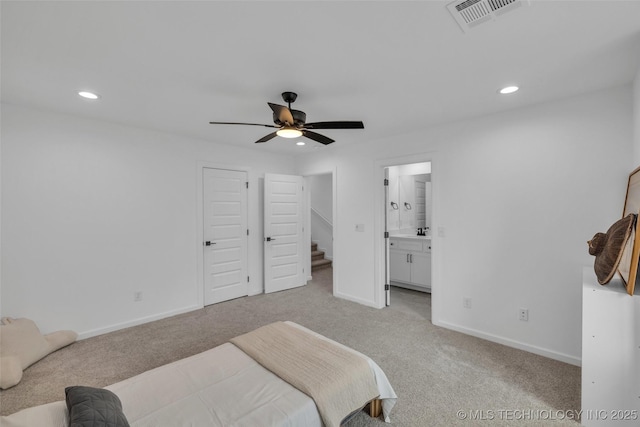 bedroom with light carpet, connected bathroom, and ceiling fan