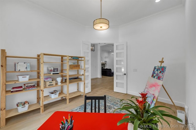 recreation room with hardwood / wood-style floors and crown molding