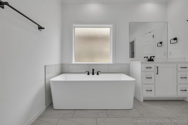 bathroom featuring vanity and a washtub