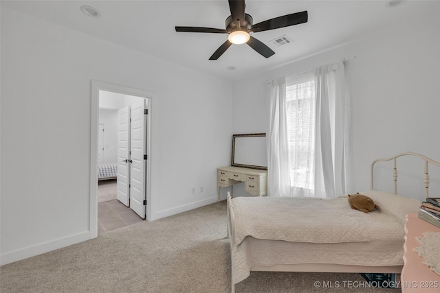 carpeted bedroom with connected bathroom and ceiling fan