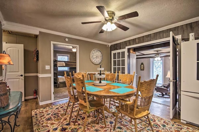 dining room featuring hardwood / wood-style floors, crown molding, and a wealth of natural light