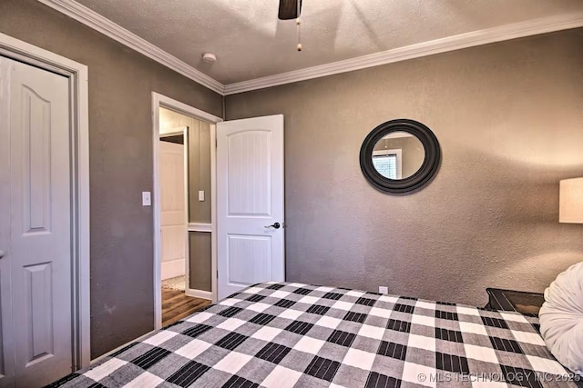 unfurnished bedroom with ceiling fan, ornamental molding, and a textured ceiling