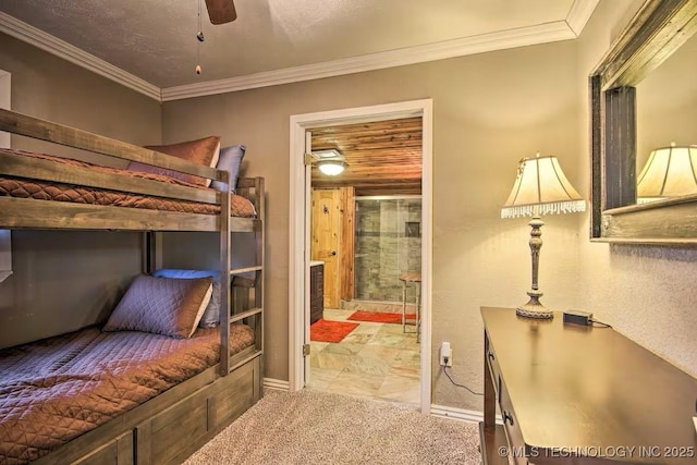 carpeted bedroom featuring crown molding and connected bathroom