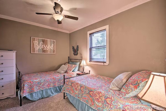 carpeted bedroom with ornamental molding and ceiling fan