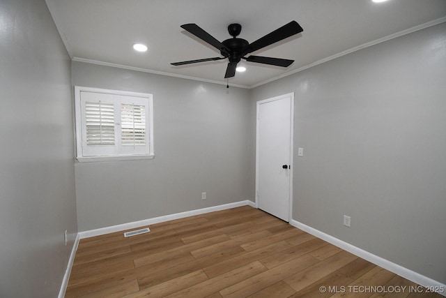 spare room with ornamental molding, ceiling fan, and light hardwood / wood-style flooring