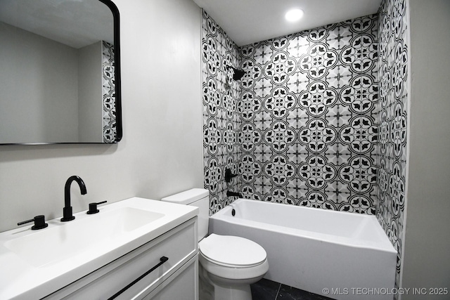 full bathroom featuring vanity, tiled shower / bath combo, and toilet