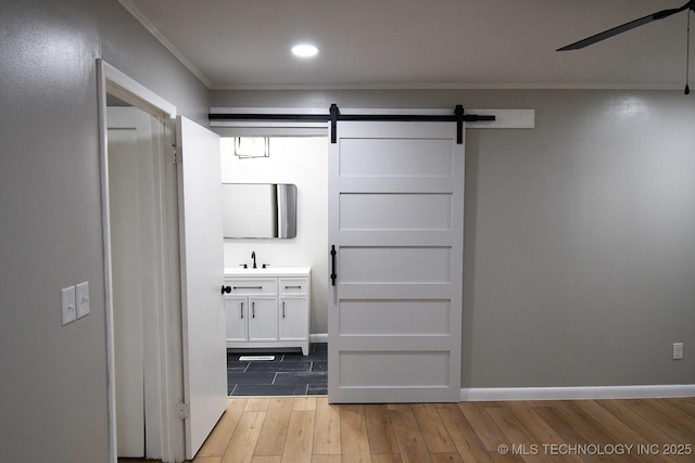 bathroom featuring vanity, ornamental molding, and hardwood / wood-style floors