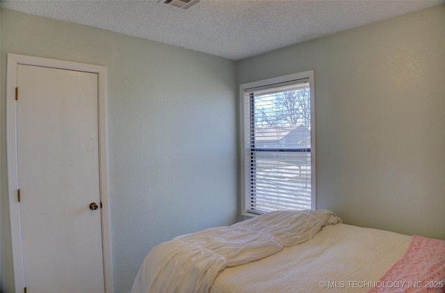 bedroom featuring a textured ceiling