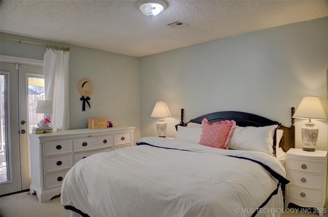 carpeted bedroom with a textured ceiling