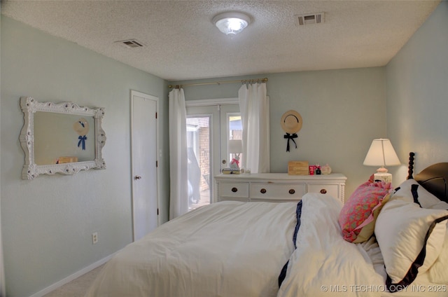 bedroom featuring a textured ceiling and carpet flooring