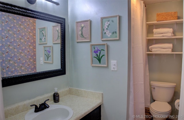 bathroom featuring vanity and toilet