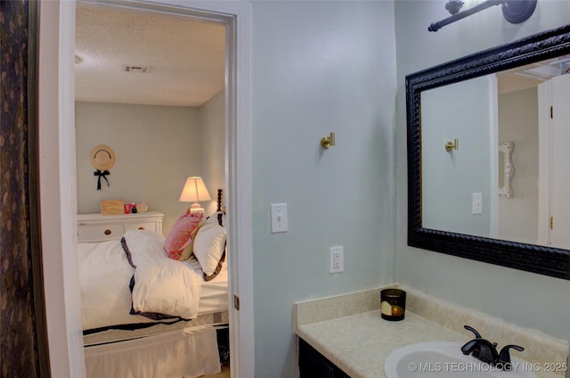 bathroom featuring vanity and a textured ceiling