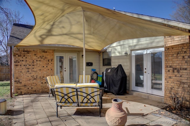 view of patio with outdoor lounge area, a grill, and french doors