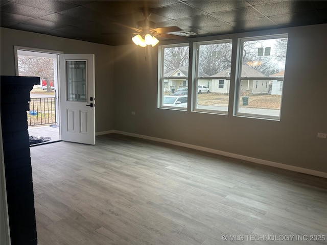 unfurnished room with hardwood / wood-style flooring and a paneled ceiling