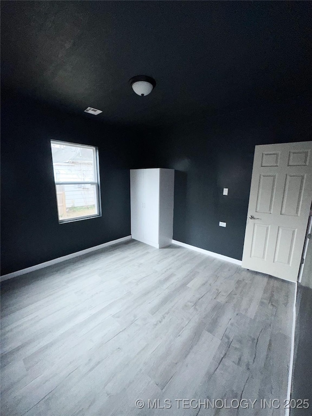 unfurnished bedroom with light hardwood / wood-style floors