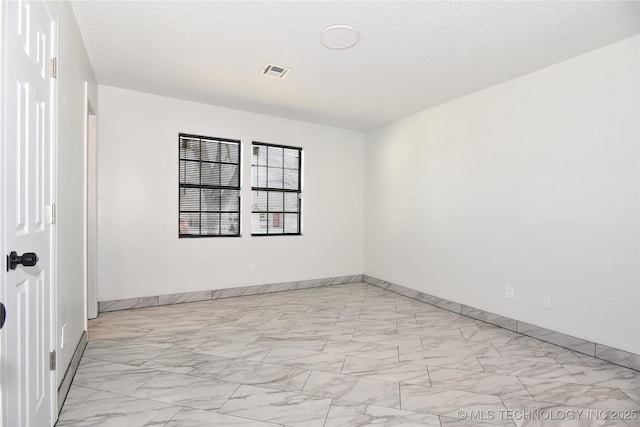 empty room with a textured ceiling