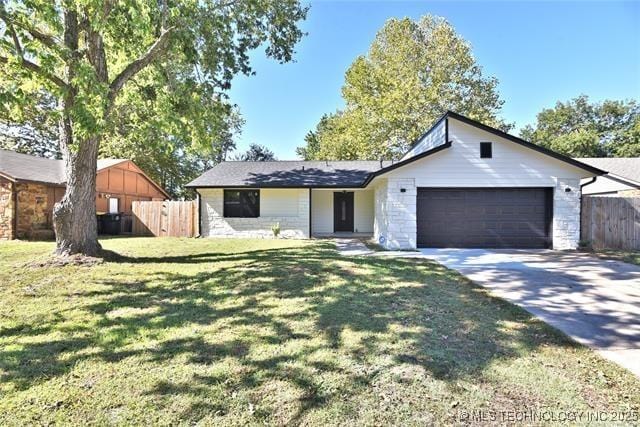 ranch-style house featuring a garage and a front yard