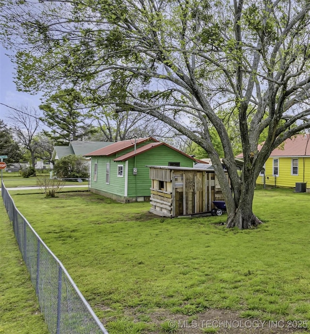 exterior space with cooling unit and a lawn