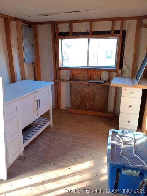 miscellaneous room with electric panel and light wood-type flooring