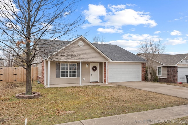 view of front of property featuring a garage and a front lawn