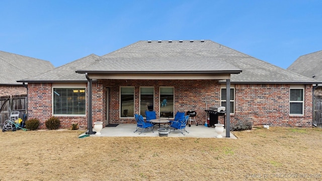 rear view of property with a patio and a yard