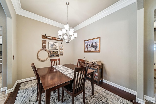 dining space featuring ornamental molding, dark hardwood / wood-style floors, and a chandelier