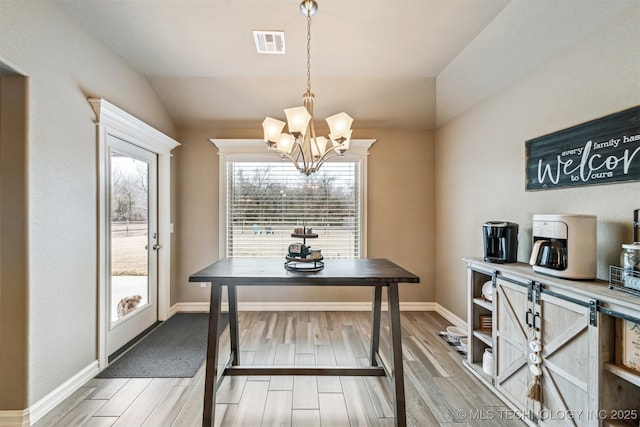 dining room featuring vaulted ceiling and a chandelier