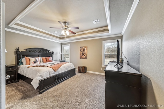 bedroom featuring multiple windows, carpet floors, ornamental molding, and a raised ceiling