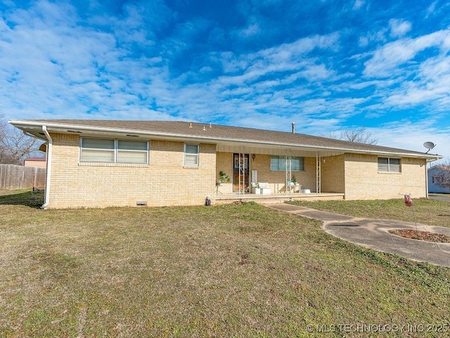 rear view of house with a yard and a patio area