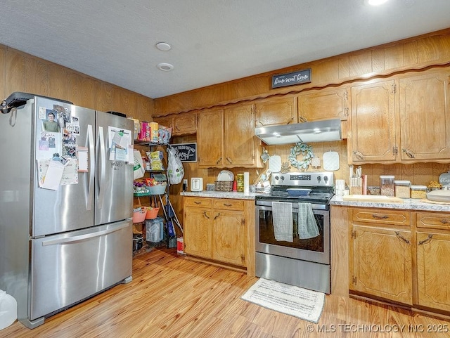 kitchen with light wood-type flooring and appliances with stainless steel finishes