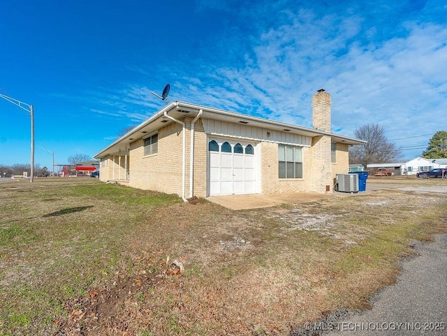 view of home's exterior featuring a yard, a garage, and central air condition unit