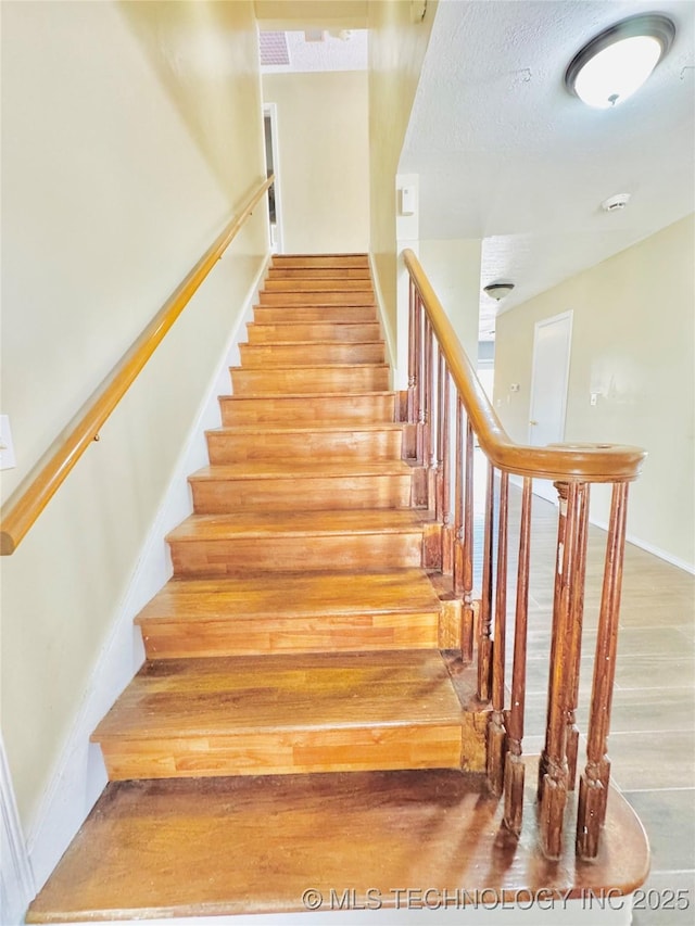 stairway with hardwood / wood-style floors