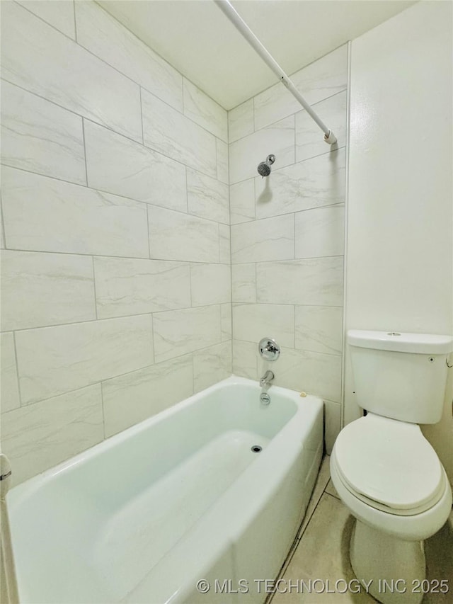 bathroom featuring tiled shower / bath combo and toilet