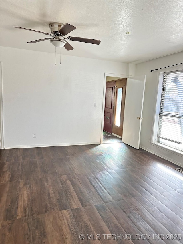 unfurnished room featuring ceiling fan, a textured ceiling, and dark hardwood / wood-style flooring