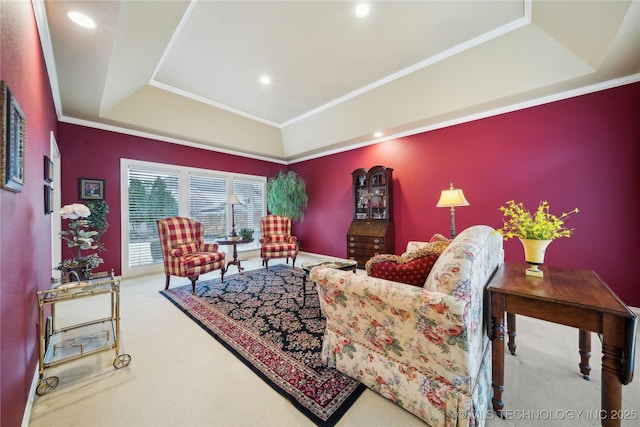 carpeted living room featuring ornamental molding and a tray ceiling