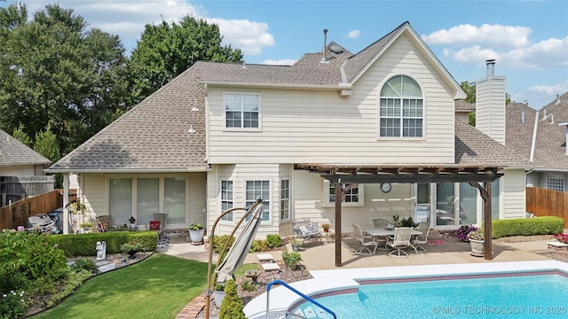 back of house featuring a yard, a pergola, and a patio