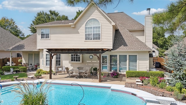 rear view of house featuring a patio and a pergola