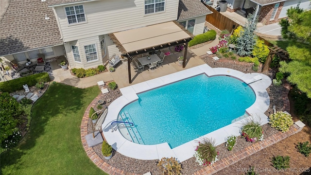 view of swimming pool featuring a patio and a lawn